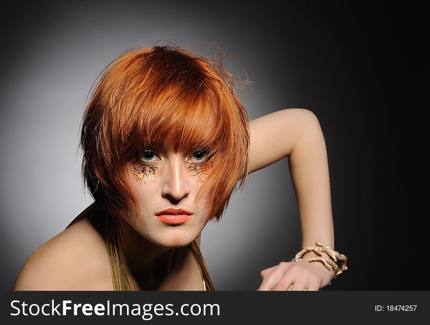 Beautiful red heaired woman portrait with creative trendy make-up and fashion hairstyle. Beautiful red heaired woman portrait with creative trendy make-up and fashion hairstyle