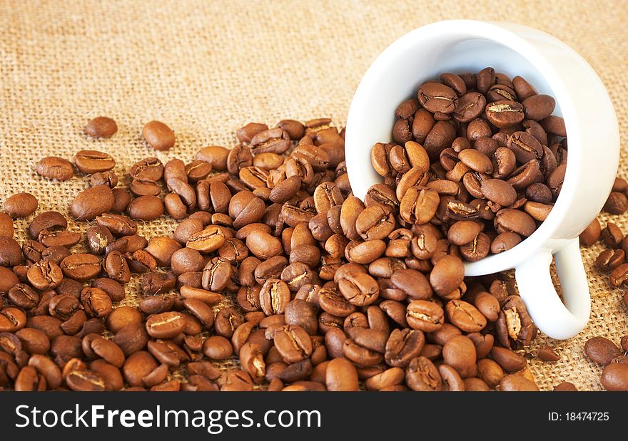 Cup filled with coffee beans