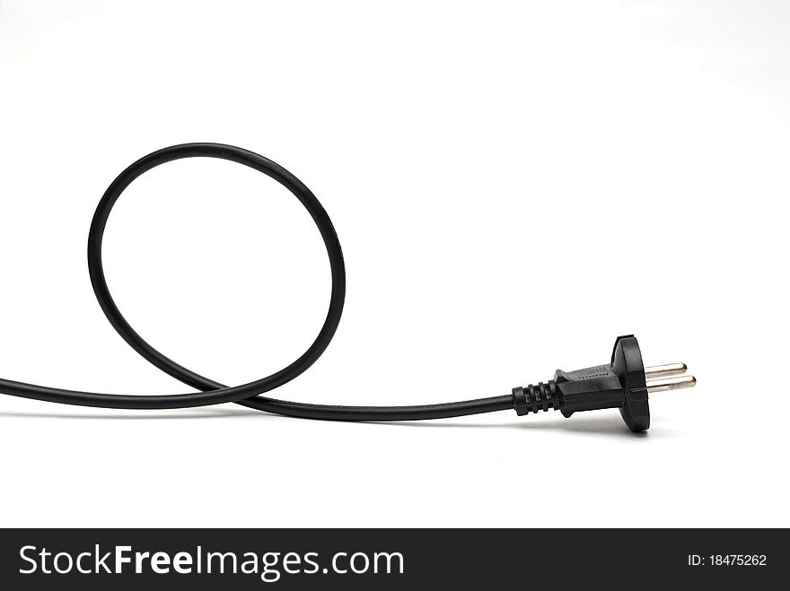 Black cable is twisted into a helix on a white background.