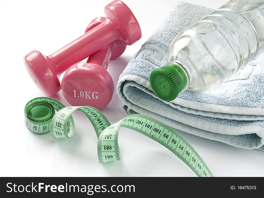 A pair of dumbbells, a towel and water.