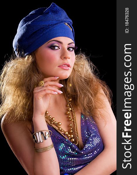 Beautiful girl in a turban and a stylized ethnic costume