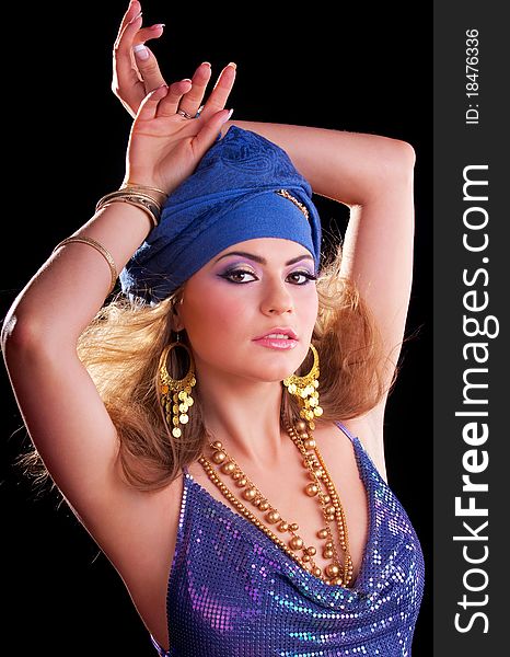 Beautiful girl in a turban and a stylized ethnic costume