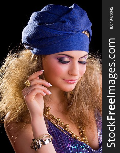 Beautiful girl in a turban and a stylized ethnic costume