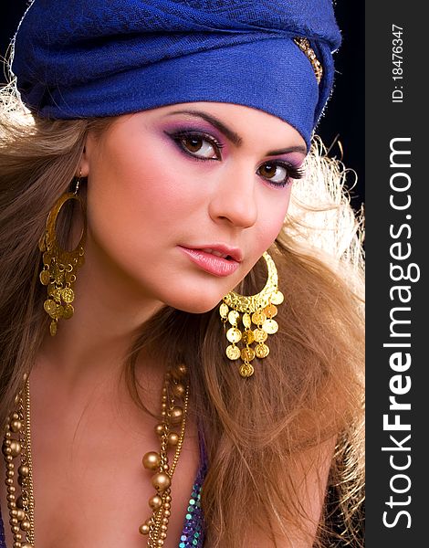 Beautiful girl in a turban and a stylized ethnic costume