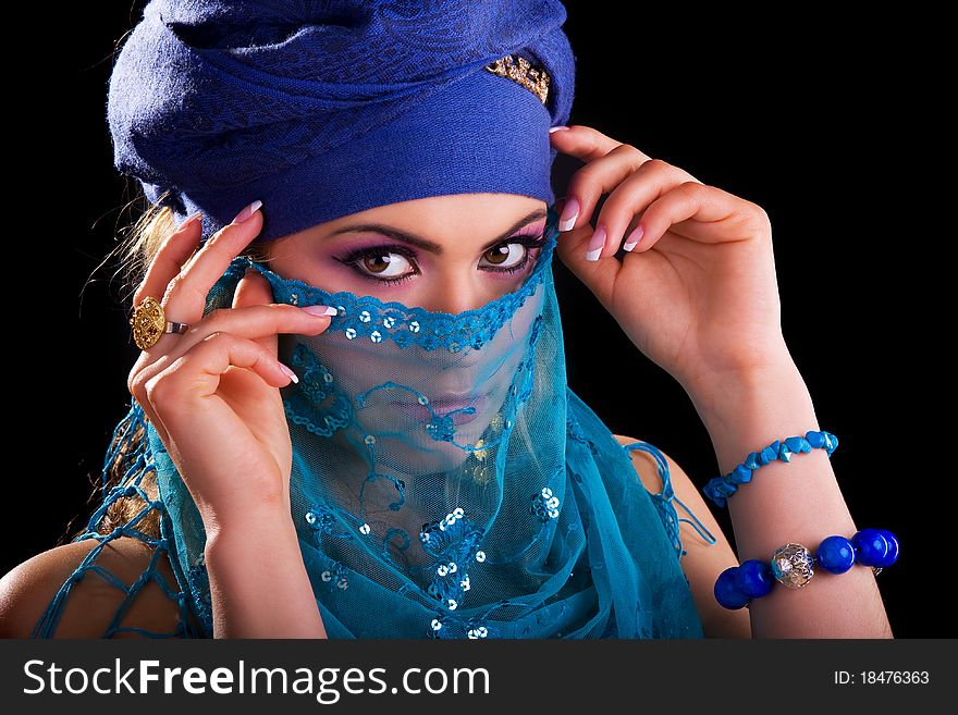 Beautiful girl in the stylized ethnic turban and veil