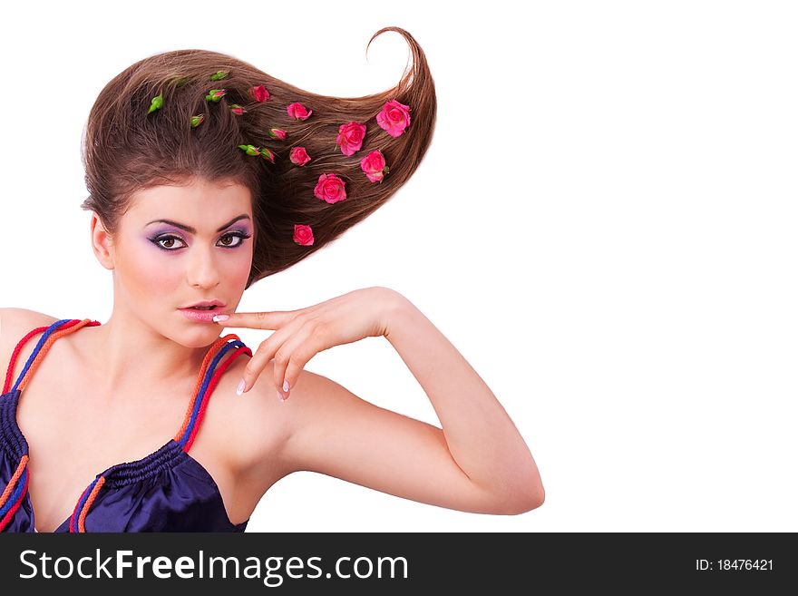 Pretty girl lying with flowers-roses in her hair