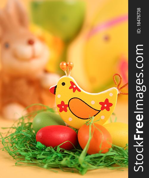 Easter bunny with colored eggs on yellow background