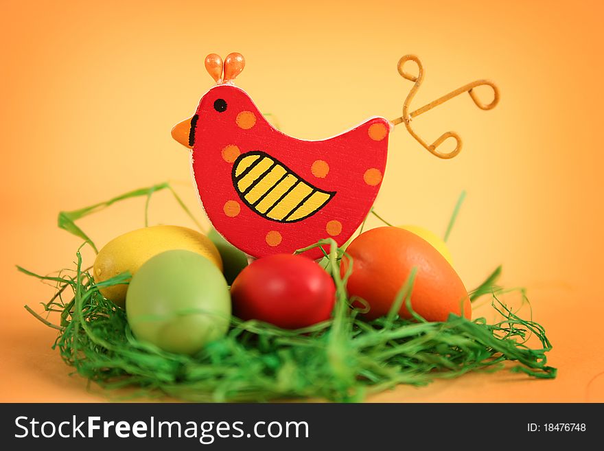 Easter chicken with colored eggs