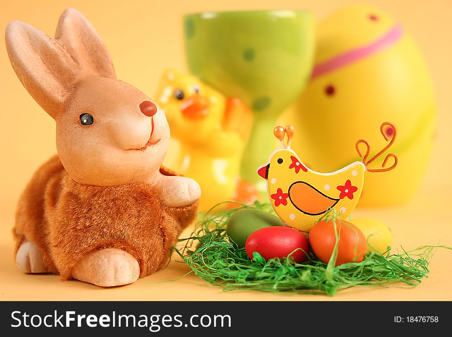 Easter bunny with colored eggs on yellow background. Easter bunny with colored eggs on yellow background