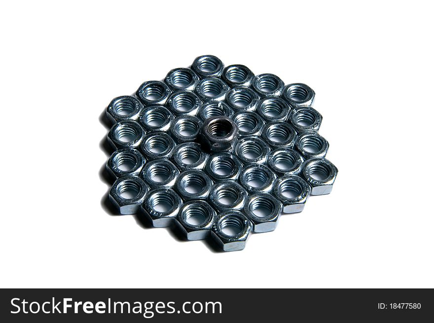 Isolated group of metal nuts with one leader on top . Isolated group of metal nuts with one leader on top