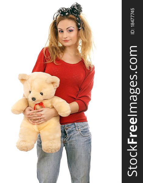 Cheerful blonde woman hugging a teddy bear. Isolated on white.