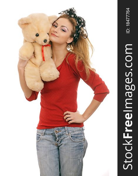 Cheerful blonde woman hugging a teddy bear. Isolated on white.
