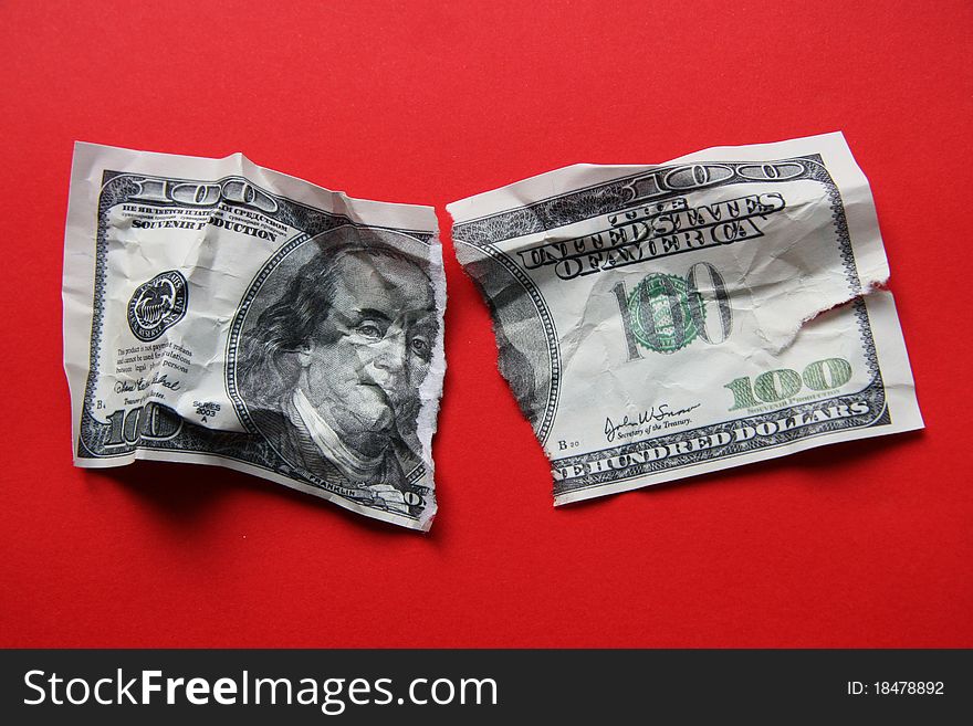 The broken off dollar on a red background