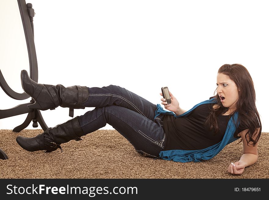 A woman is looking at her phone with a mad expression. A woman is looking at her phone with a mad expression.