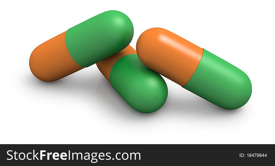 Three green and orange capsules on a white background. Three green and orange capsules on a white background