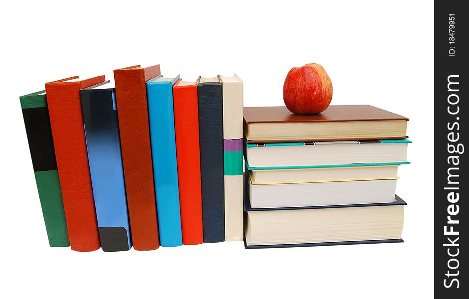 Red apple on a book isolated on white