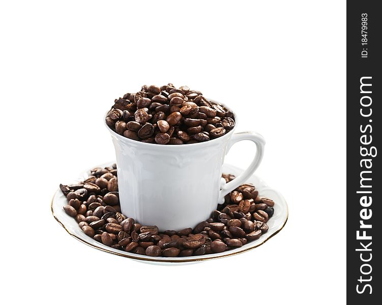 Coffee beans and white cup isolated on white