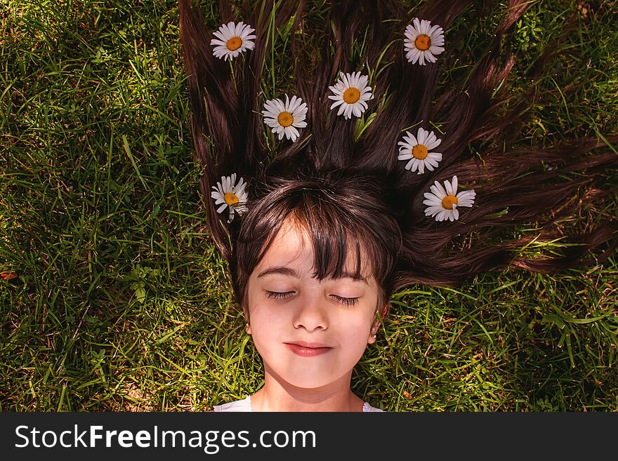 Girl with daisies in hands on the field. Selective focus.flower