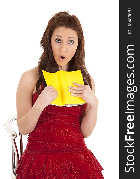 Woman red dress surprised at book