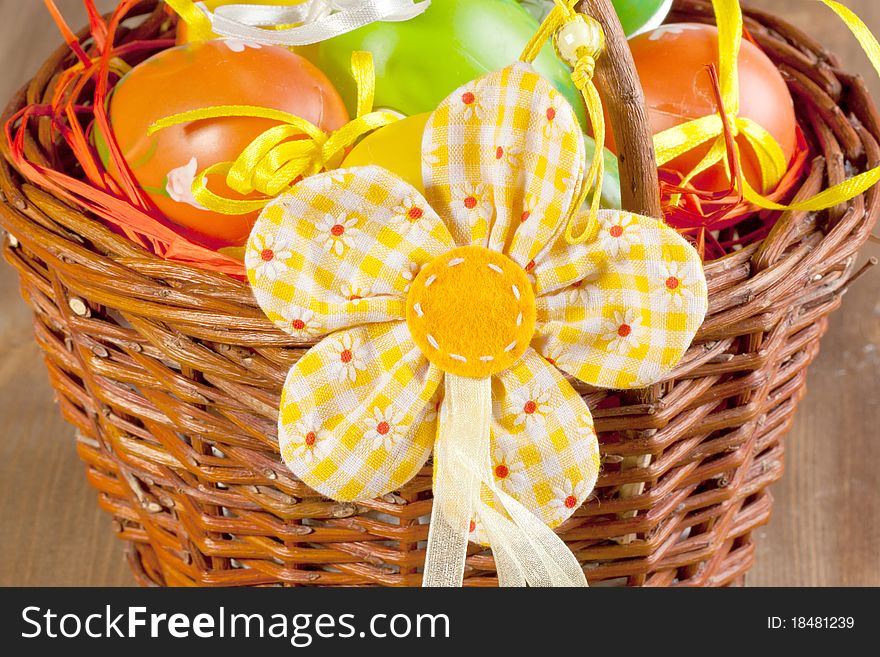 Easter eggs in basket with easter flower