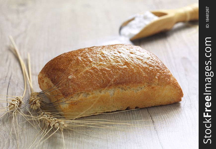 A close up of a baked bread on a wooden surface