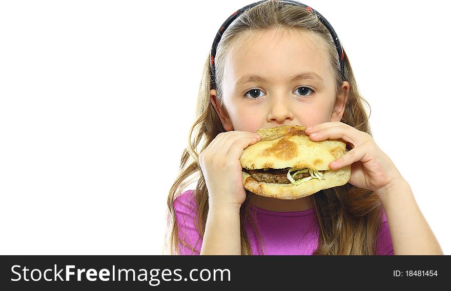 Little girl eating hamburger isolated on white