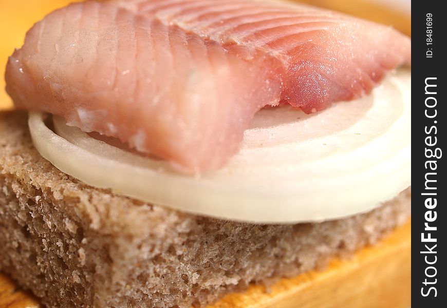 Salted fish, bread and onion closeup. Salted fish, bread and onion closeup