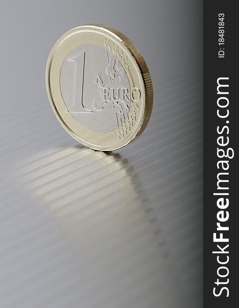 One Euro coin to a metal plate
