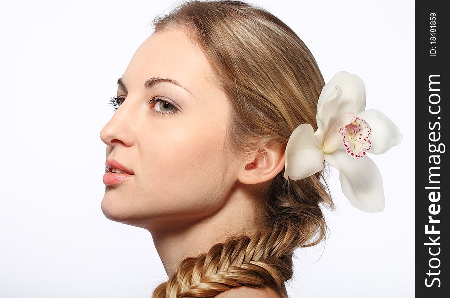 Portrait of the beauty young blond girl with orchid in her hair. Portrait of the beauty young blond girl with orchid in her hair