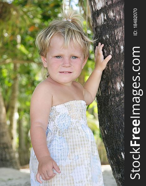 Young girl near palm tree