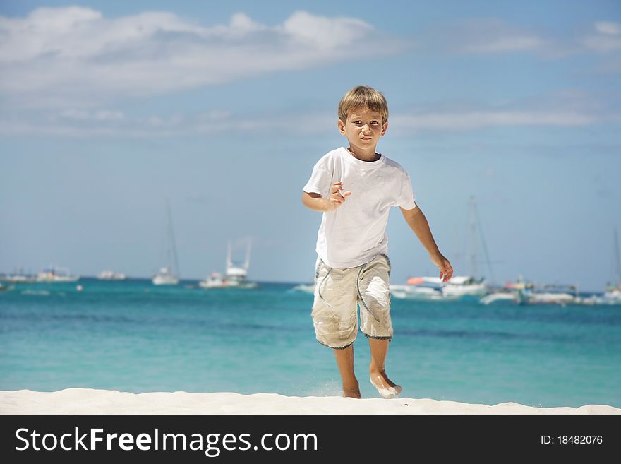 Young boy running on sea background