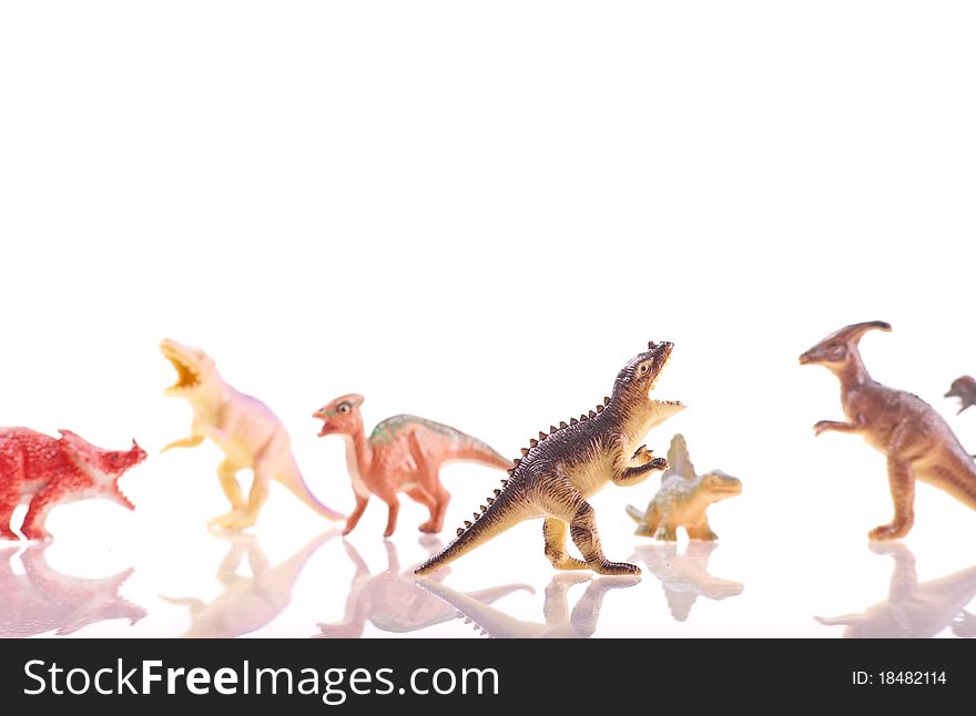 Tyrannosaurus Rex Toy Dinosaur with Other Dinosaur Figures in Background