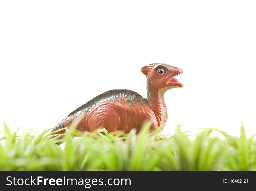 Toy Dinosaur In Grass