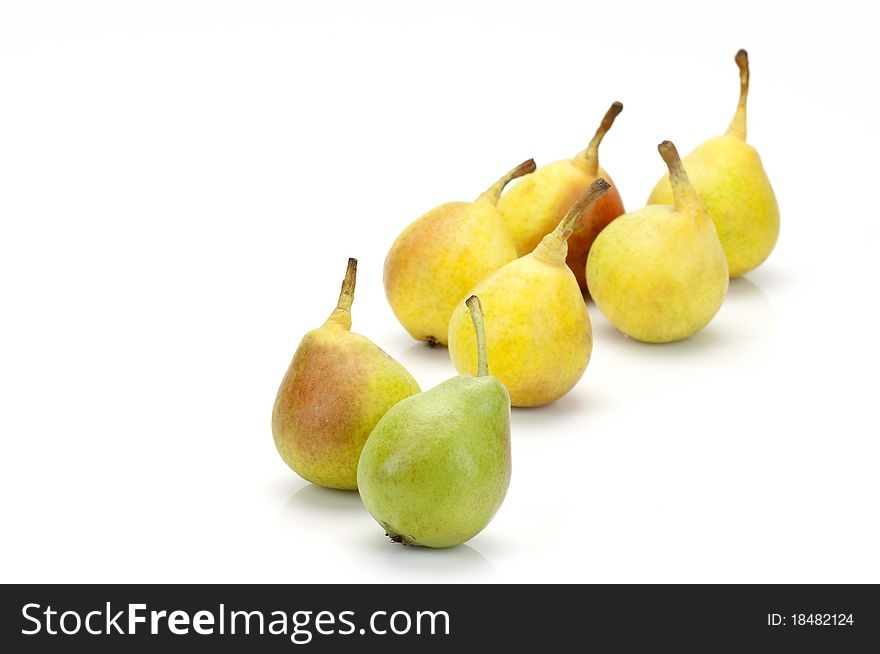 A variety of green and yellow pears on white. A variety of green and yellow pears on white