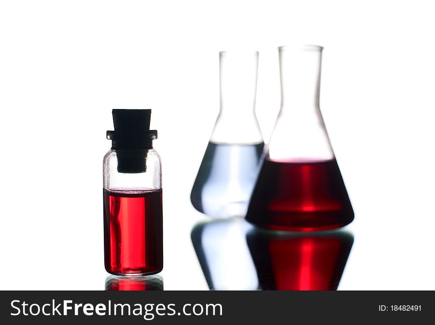 Laboratory flasks with liquid. White background. Studio shot. Laboratory flasks with liquid. White background. Studio shot.