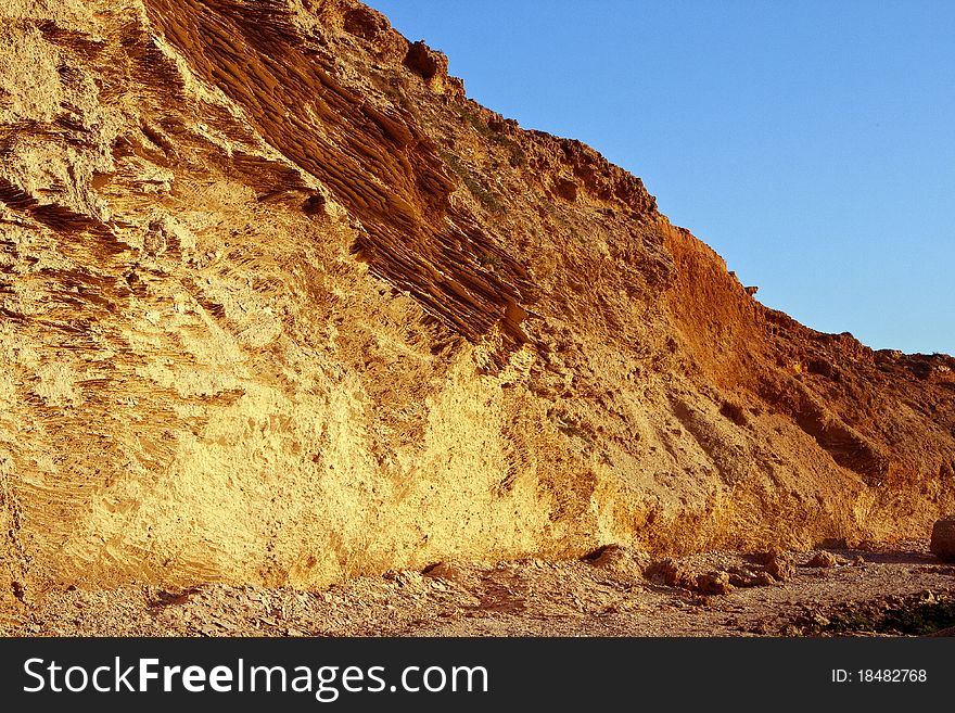 View of ancient coastal wall with original texture of limestone. Mediterranean. View of ancient coastal wall with original texture of limestone. Mediterranean.