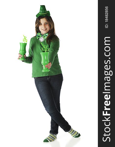 An attractive young teen offering the viewer one of her two green mugs with shamrock-shaped straws. Isolated on white. An attractive young teen offering the viewer one of her two green mugs with shamrock-shaped straws. Isolated on white.