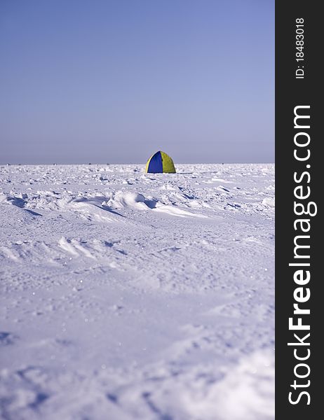 Tent on sea ice and blue snow