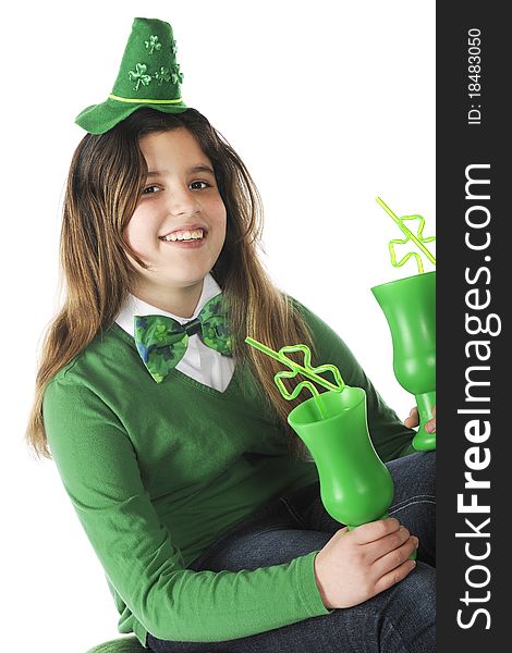 A happy preteen holding two green cups and dressed for St. Patrick's Day celebration. Isolated on white. A happy preteen holding two green cups and dressed for St. Patrick's Day celebration. Isolated on white.