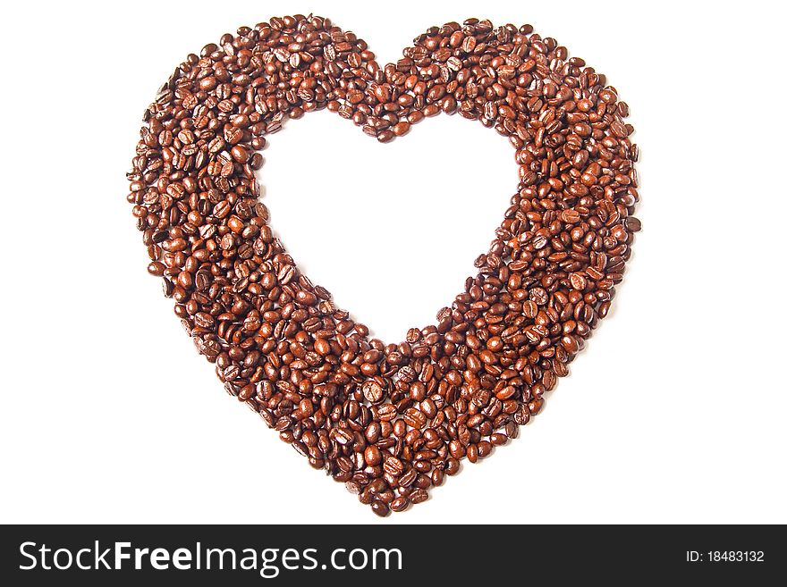 Heart from brown coffee beans on white background