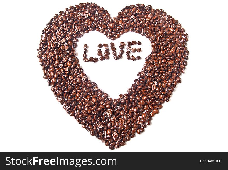 Heart from brown coffee beans and word of love on white background