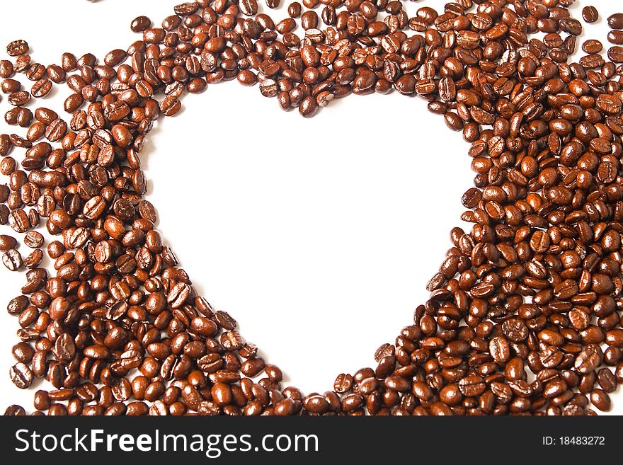 Heart from brown coffee beans on white background