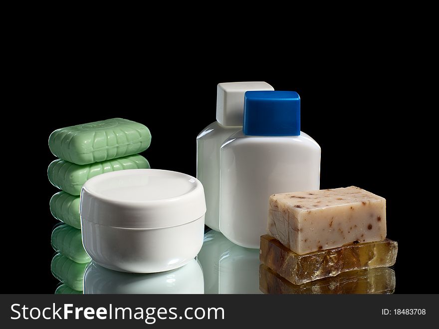 Soap pieces with cream and two cosmetic bottles. Soap pieces with cream and two cosmetic bottles.