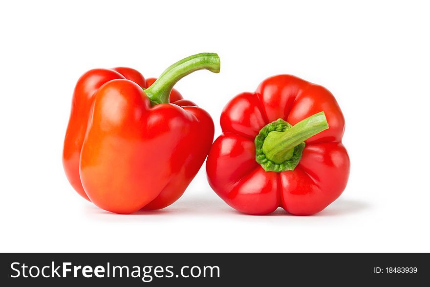 Two red fresh peppers on a white background