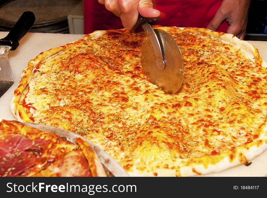 Cutting Pizza in Slices at the restaurant