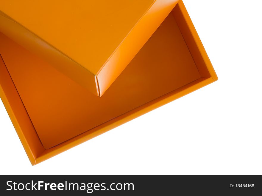 Orange cardboard box on the top of the frame isolated on white background. Orange cardboard box on the top of the frame isolated on white background