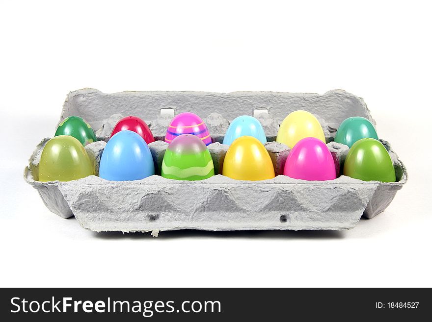 Multi-colored plastic Easter eggs in cardboard carton. Multi-colored plastic Easter eggs in cardboard carton