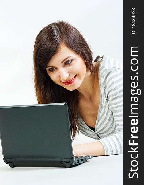 Girl with a laptop on a gray background. Girl with a laptop on a gray background