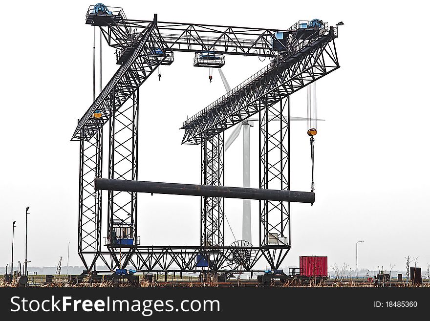 Harbor crane with pipeline in the harbor of Rotterdam