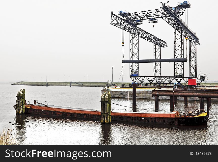 Harbor crane with pipeline in Rotterdam Harbor